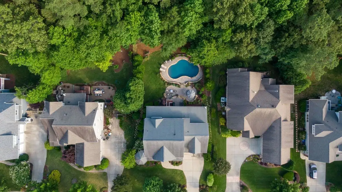 Aerial view of suburban rooftops among trees